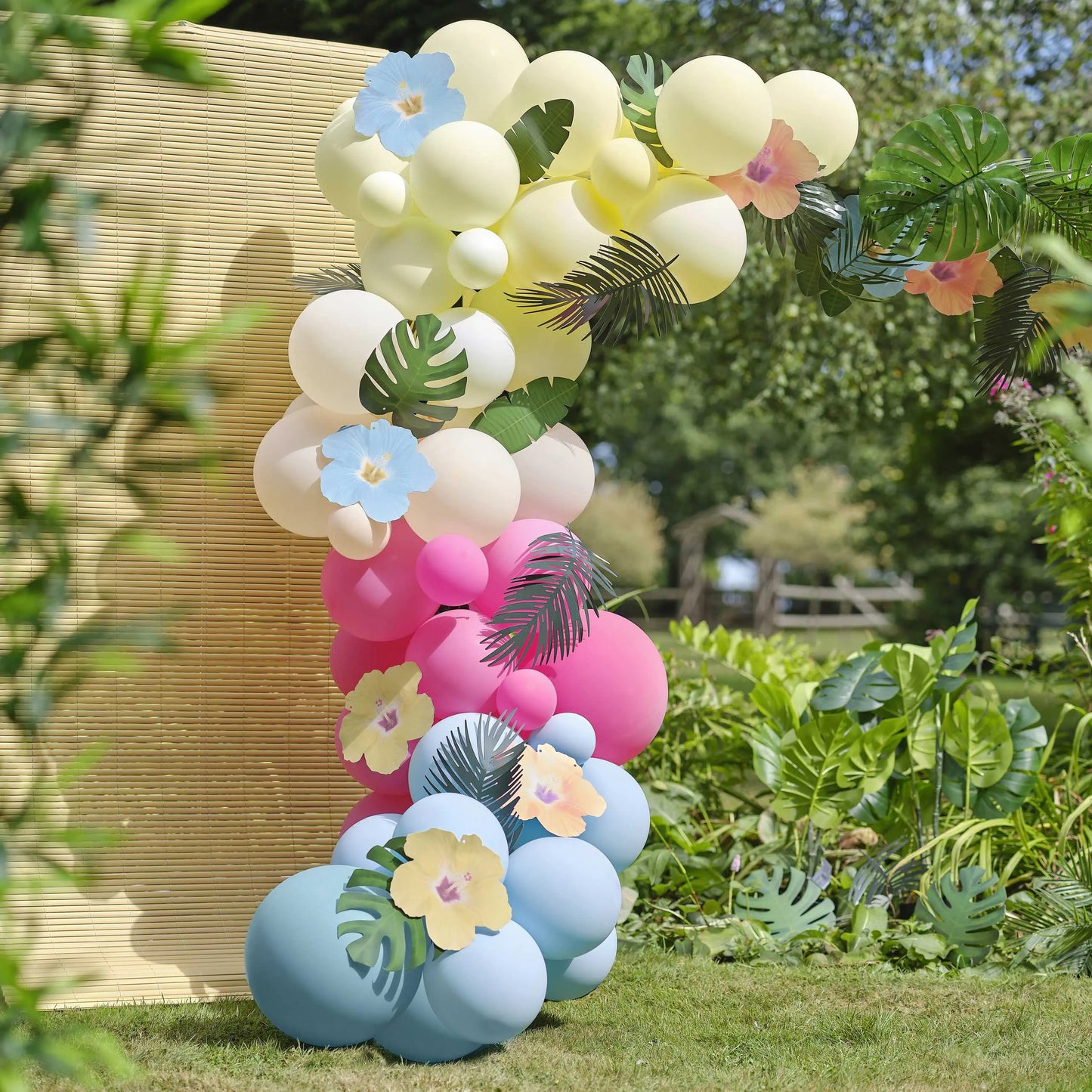 Blue, Pink, Green & Yellow Hawaiian Tiki Balloon Arch with Tropical Flowers and Foliage Ginger Ray